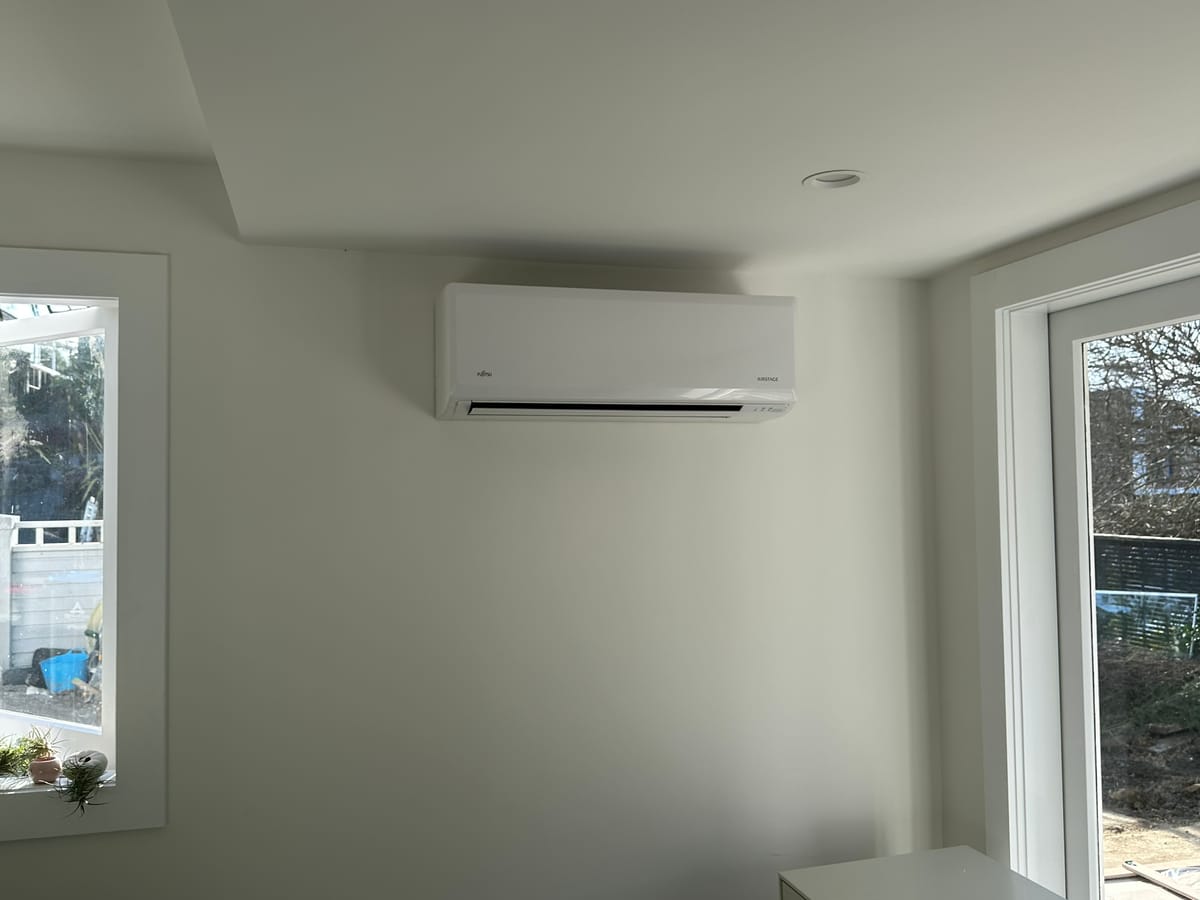 Wall-mounted Fujitsu Airstage in a new-build living space.